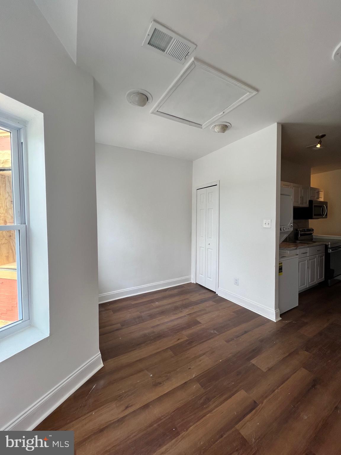 1345 1st Street Northwest, Unit 2 Washington, DC 20001 - Photo 9 of 19 a view of an empty room with wooden floor and a window