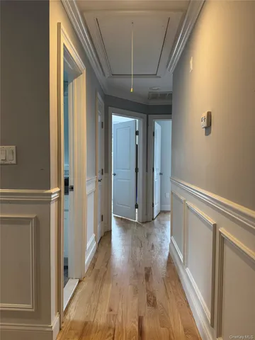 a view of hallway with wooden floor