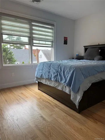 a bedroom with a bed and window