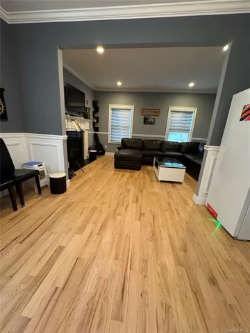 a large room with wooden floor and furniture