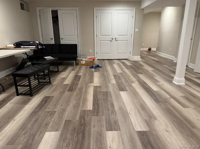 a view of a room with wooden floor and furniture