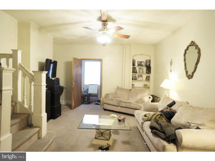 6016 West Thompson Street Philadelphia, PA 19151 - Photo 2 of 17 a living room with furniture and a chandelier