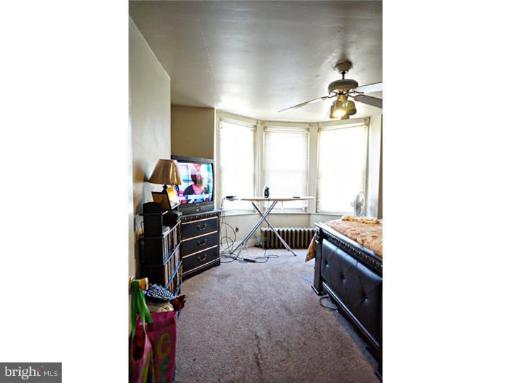 6016 West Thompson Street Philadelphia, PA 19151 - Photo 11 of 17 a living room with a couch and a flat screen tv