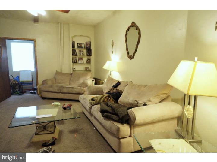 6016 West Thompson Street Philadelphia, PA 19151 - Photo 3 of 17 a living room with furniture and a white wall