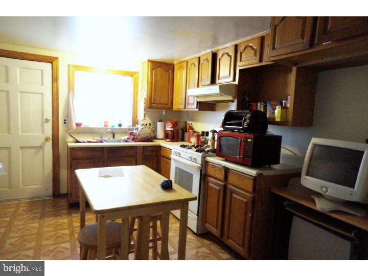 6016 West Thompson Street Philadelphia, PA 19151 - Photo 7 of 17 a kitchen with a sink cabinets and a window