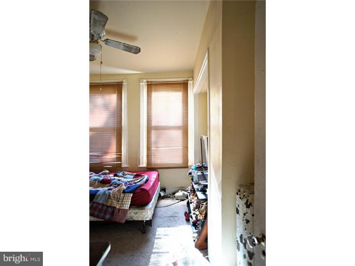 6016 West Thompson Street Philadelphia, PA 19151 - Photo 10 of 17 a bedroom with furniture and a window