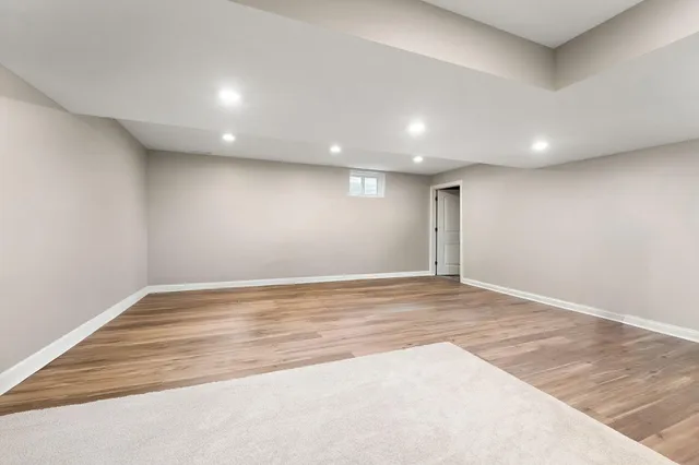 a living room with patio furniture and a wooden floor