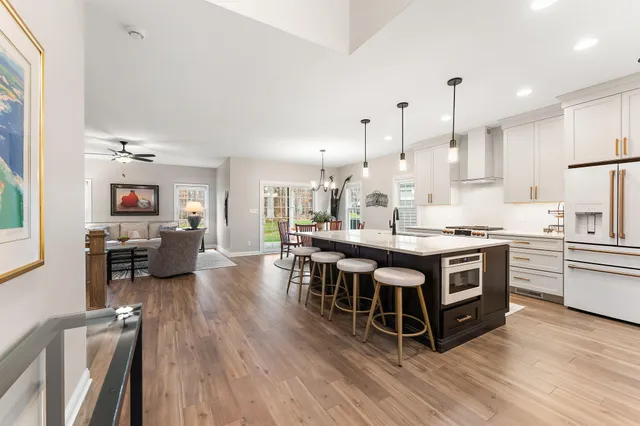a large kitchen with stainless steel appliances a lot of counter space and a wooden floors
