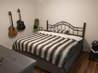 a bedroom with a bed and dresser