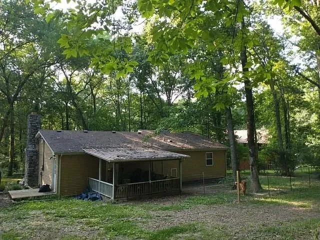 a wooden house with a yard