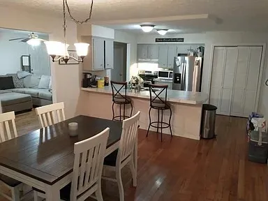 a dining room with furniture and wooden floor
