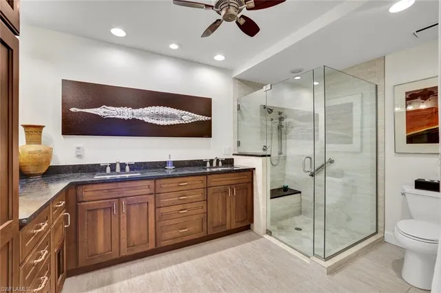 a spacious bathroom with a shower sink mirror and toilet