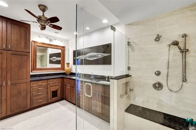 a kitchen with stainless steel appliances granite countertop a sink a stove and refrigerator