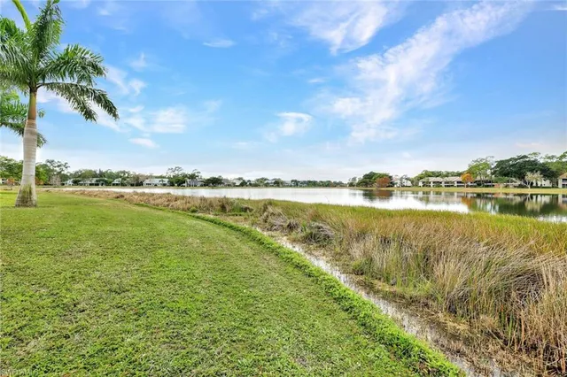 a view of a lake with houses in the back