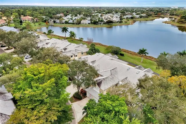 an aerial view of a houses with a lake view