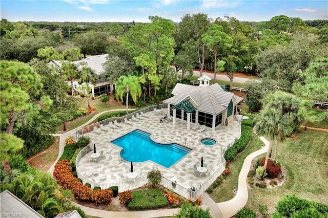 an aerial view of a house with yard swimming pool and outdoor seating