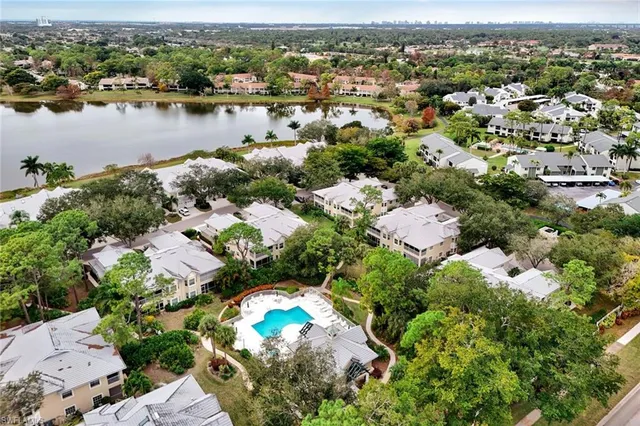 an aerial view of lake residential house with outdoor space and trees