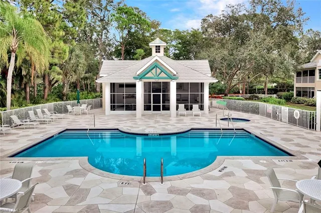 a view of a house with swimming pool and sitting area