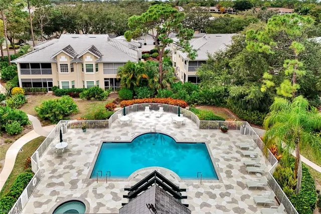 an aerial view of a house with garden space and swimming pool