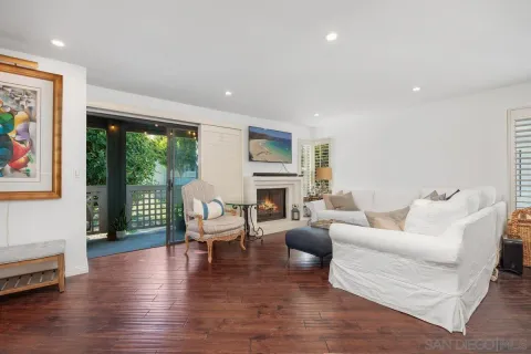 a living room with furniture large window and a fireplace
