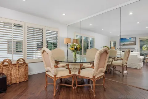 a dining room with furniture and wooden floor
