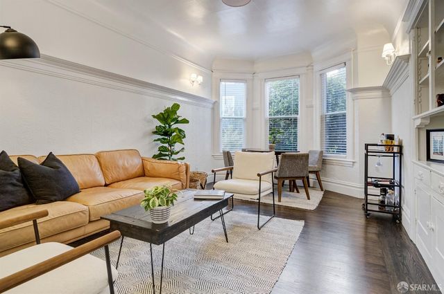 a bedroom with a bed and a wooden floor