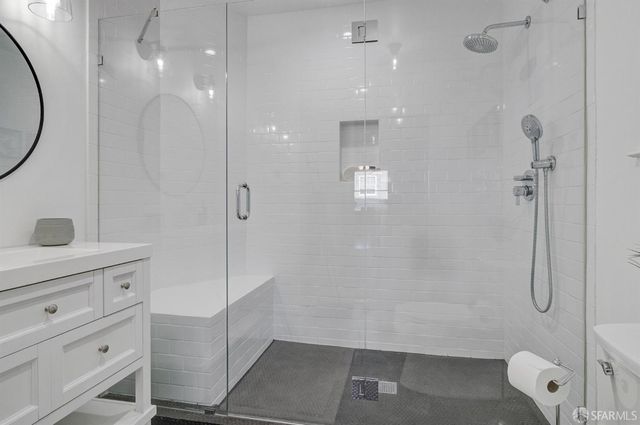 a bathroom with a sink double vanity and a shower