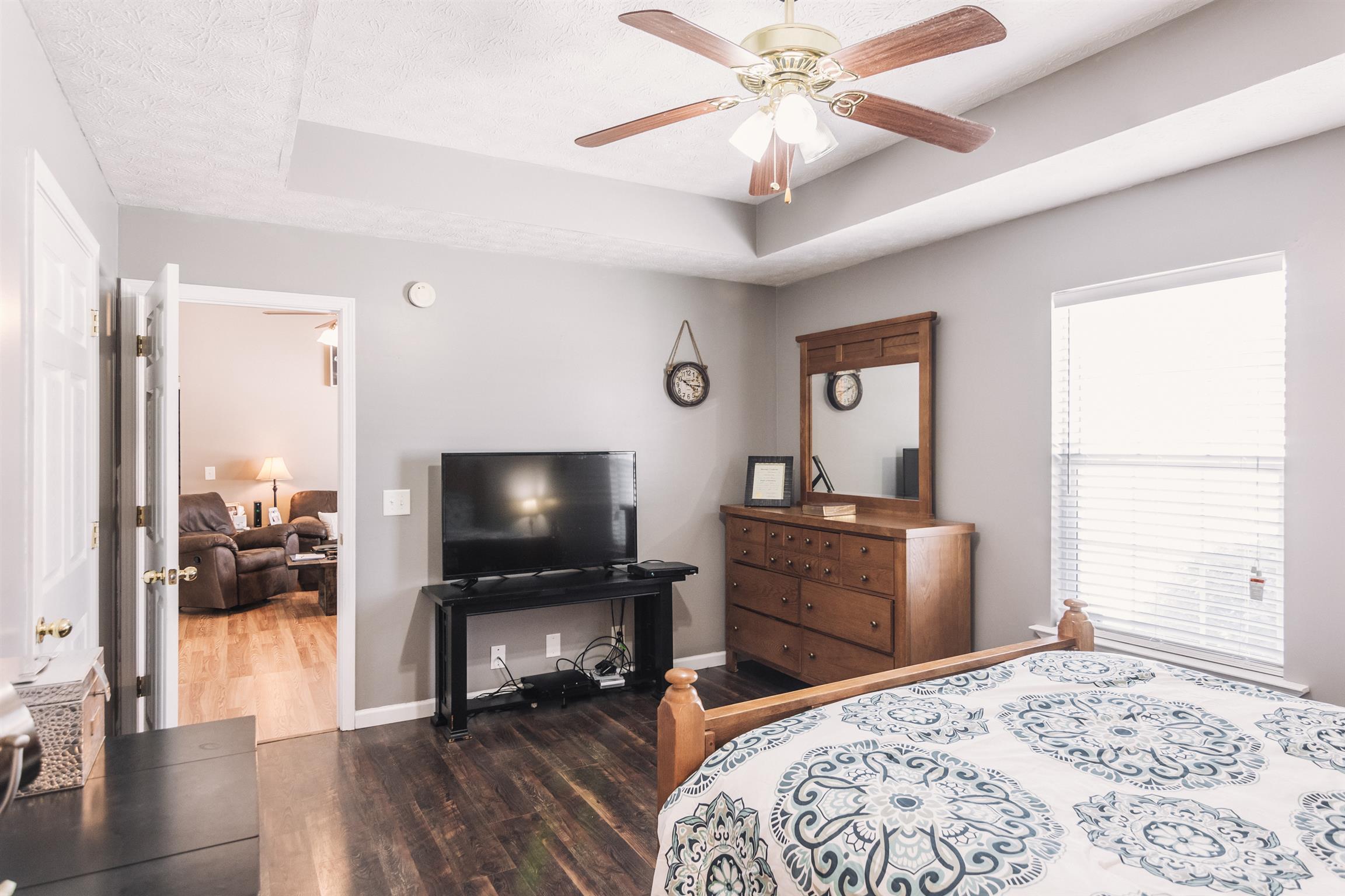 399 Corinth Road Portland, TN 37148 - Photo 13 of 28 a bedroom with a bed and a chandelier