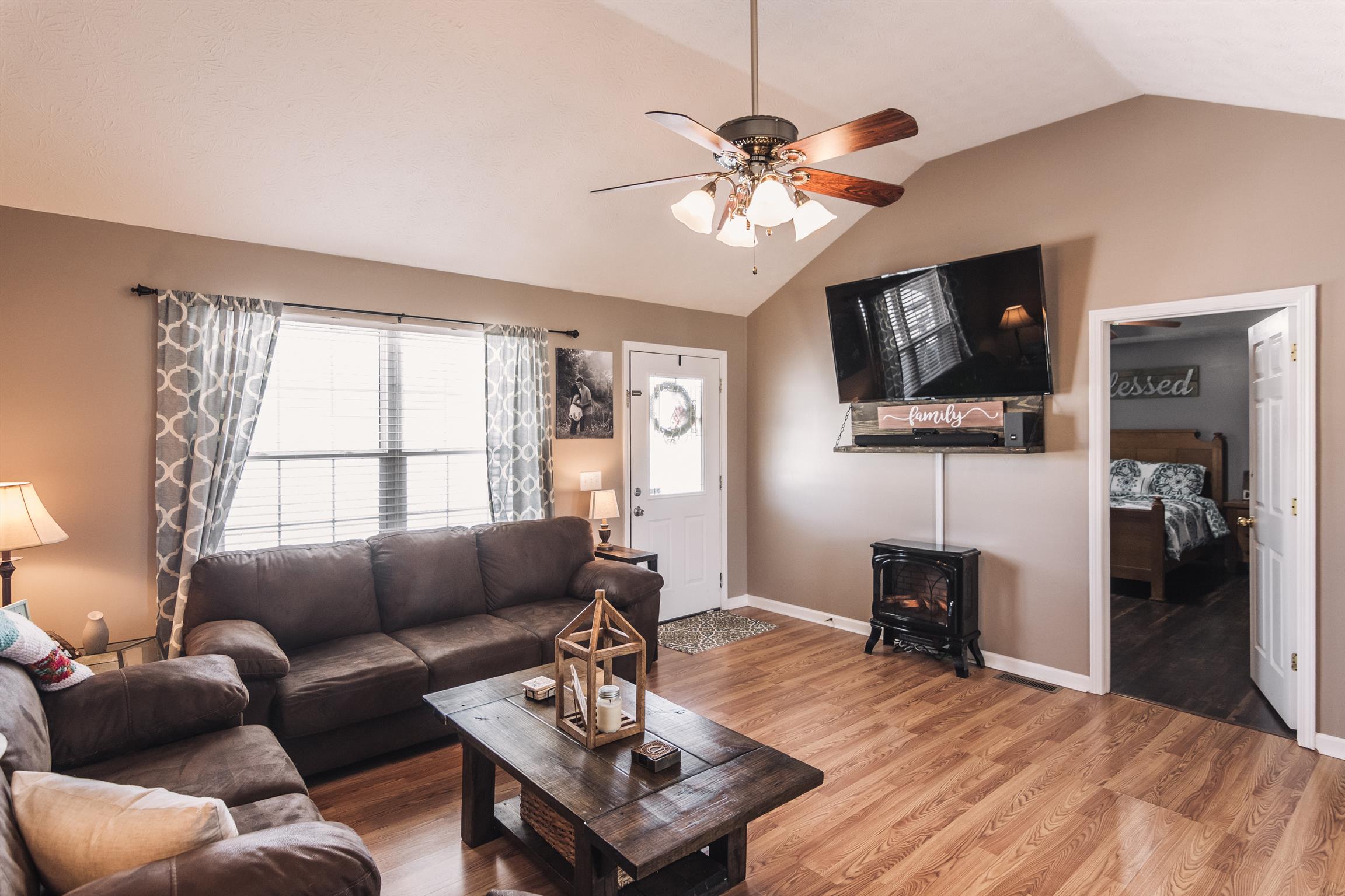 399 Corinth Road Portland, TN 37148 - Photo 3 of 28 a living room with furniture a flat screen tv and a window