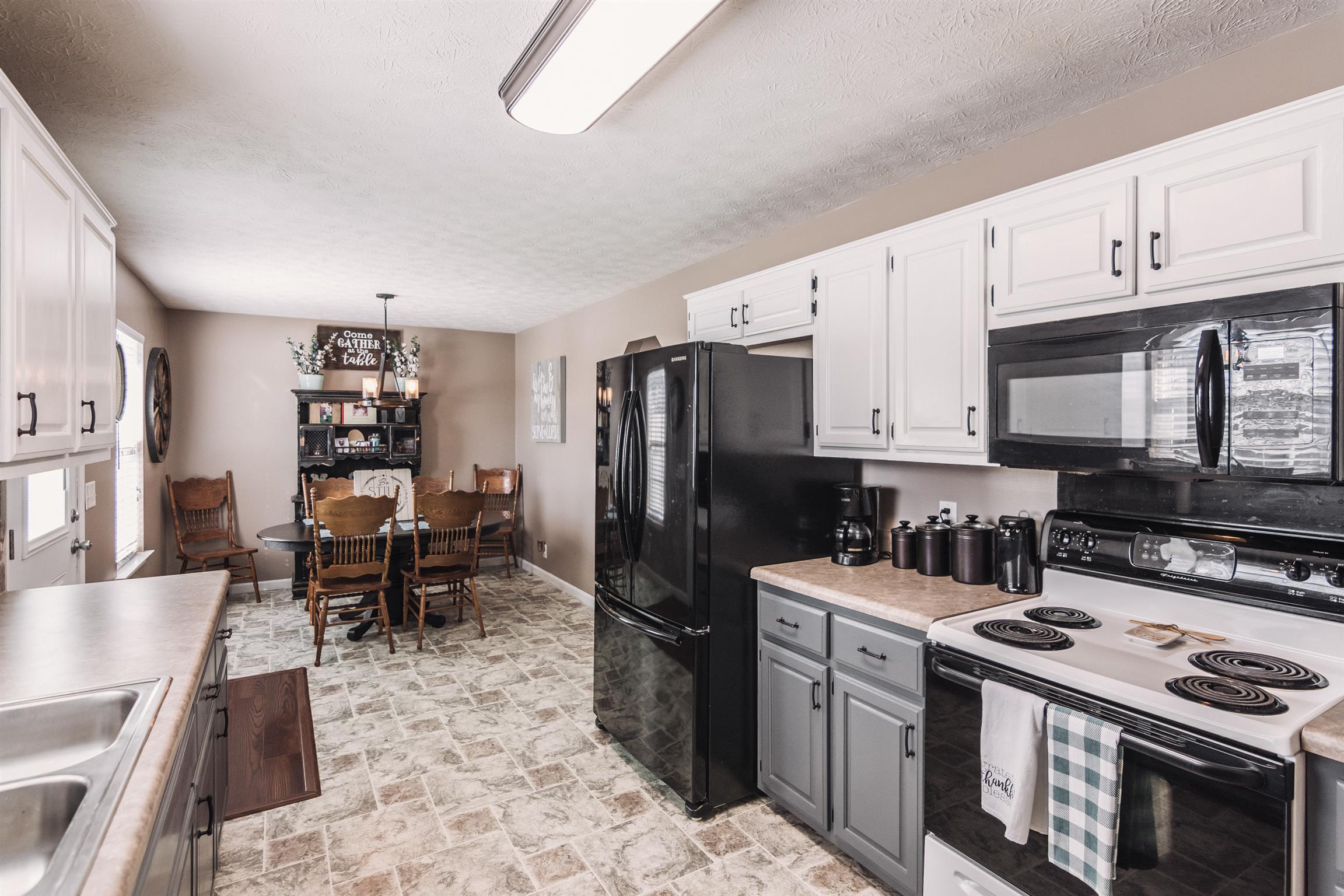 399 Corinth Road Portland, TN 37148 - Photo 5 of 28 a kitchen with a stove a refrigerator and cabinets