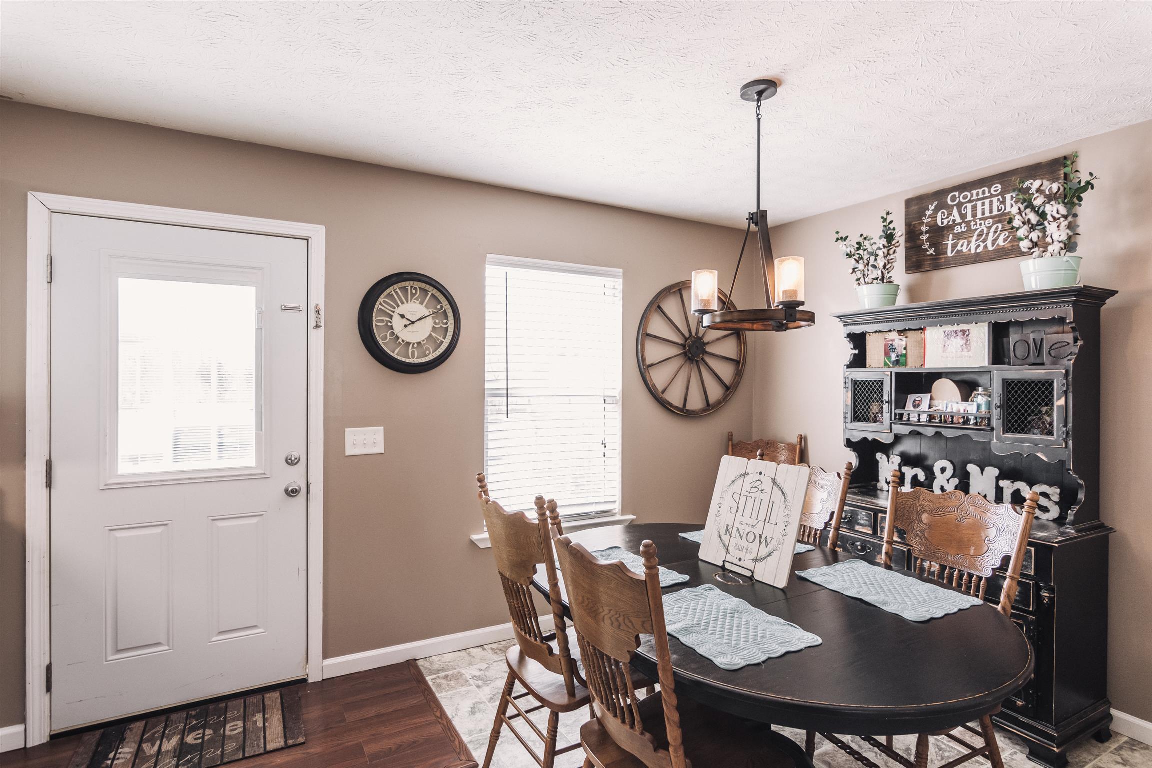 399 Corinth Road Portland, TN 37148 - Photo 6 of 28 a view of a dining room with furniture wall and a chandelier
