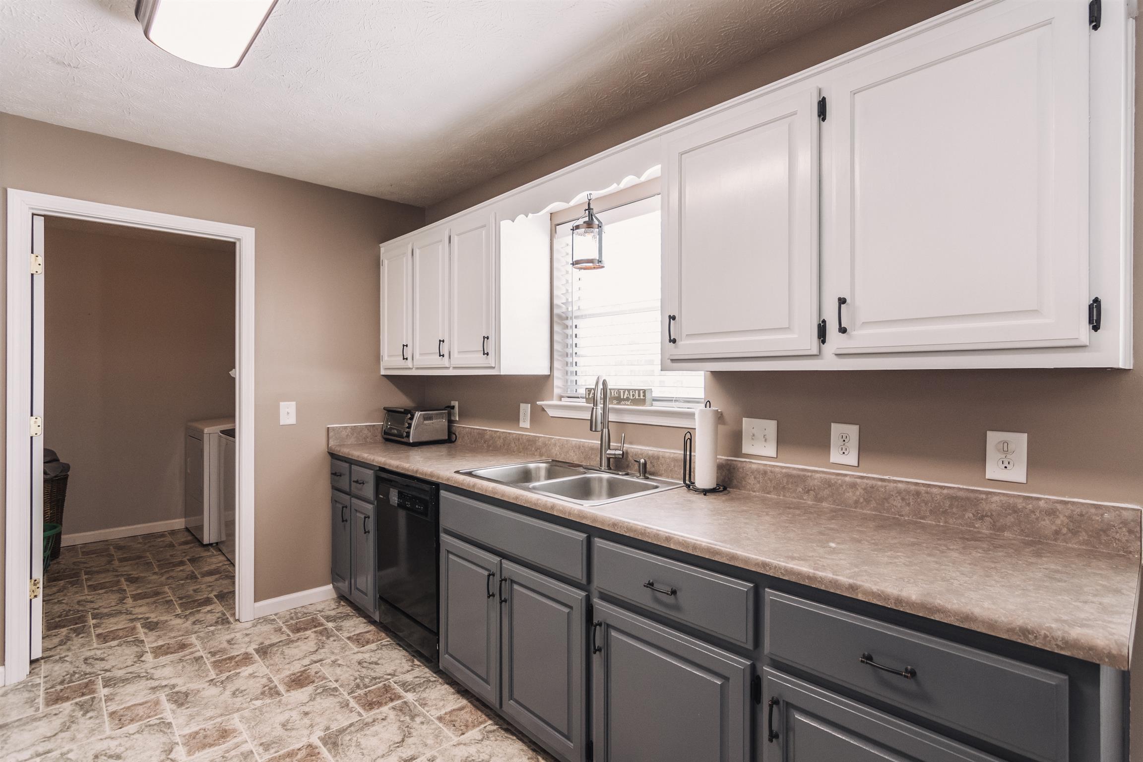 399 Corinth Road Portland, TN 37148 - Photo 7 of 28 a kitchen with stainless steel appliances granite countertop a sink a stove and cabinets