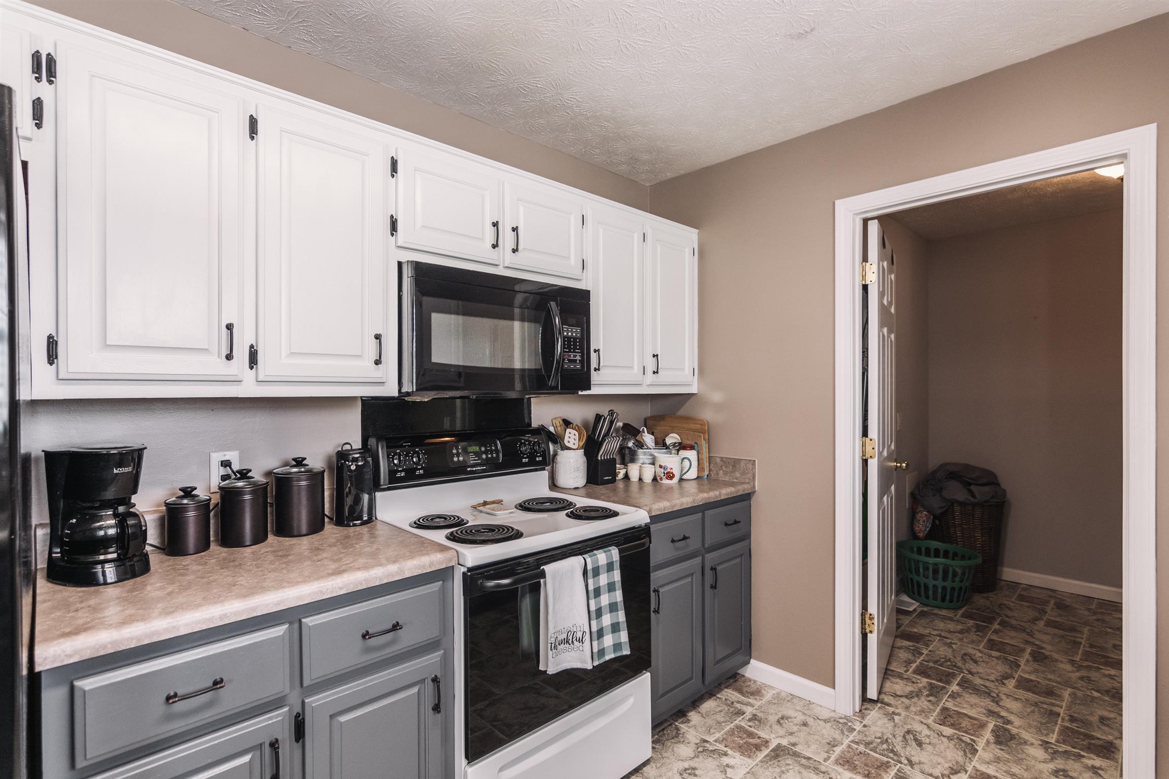 399 Corinth Road Portland, TN 37148 - Photo 8 of 28 a kitchen with stainless steel appliances granite countertop a stove a sink and a refrigerator