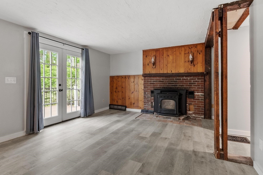 258 Allen Road Ashby, MA 01431 - Photo 15 of 36 a view of an empty room with a fireplace and a window