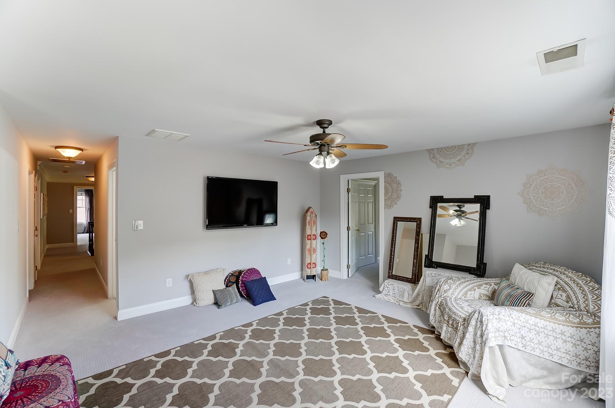 1617 Stevens Ridge Matthews, NC 28105 - Photo 35 of 42 a bedroom with a bed and a flat screen tv