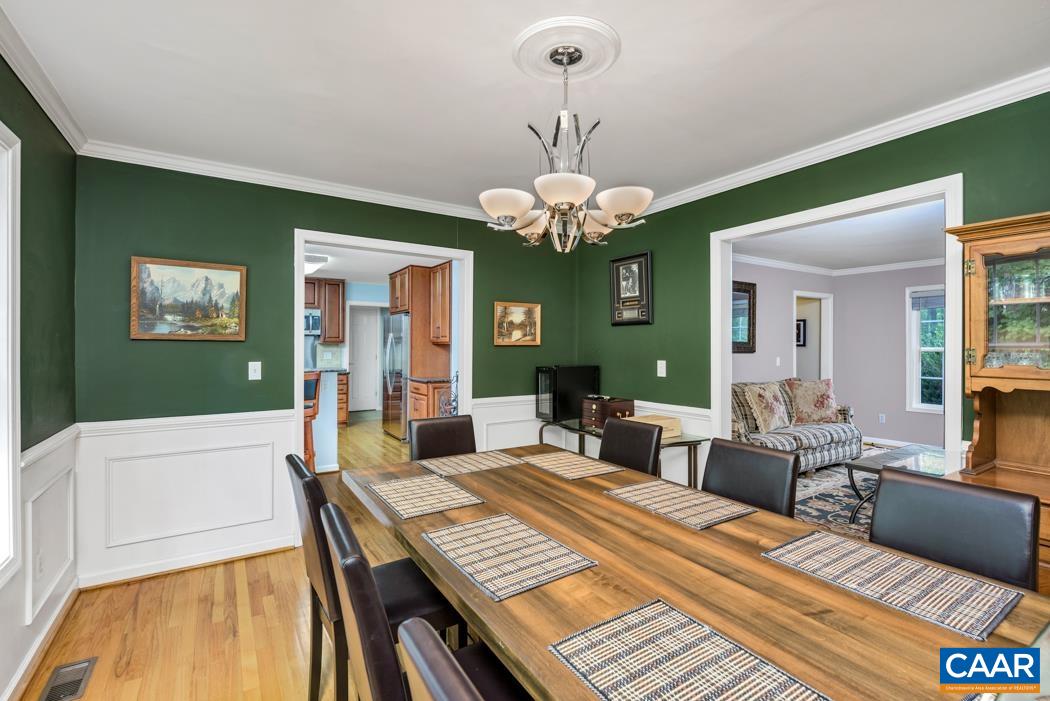 164 Wind Ridge Drive Ruckersville, VA 22968 - Photo 13 of 51 a view of a dining room with furniture a chandelier and wooden floor