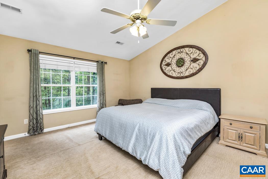 164 Wind Ridge Drive Ruckersville, VA 22968 - Photo 16 of 51 a bedroom with a bed and a large window