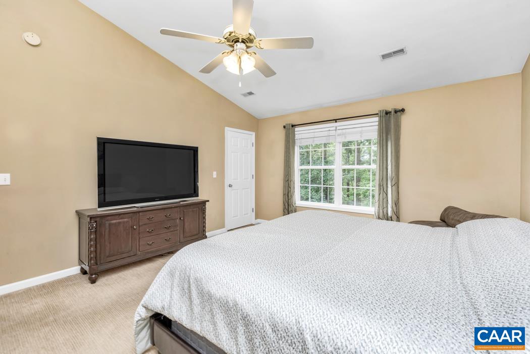 164 Wind Ridge Drive Ruckersville, VA 22968 - Photo 17 of 51 a bedroom with a bed and a flat screen tv