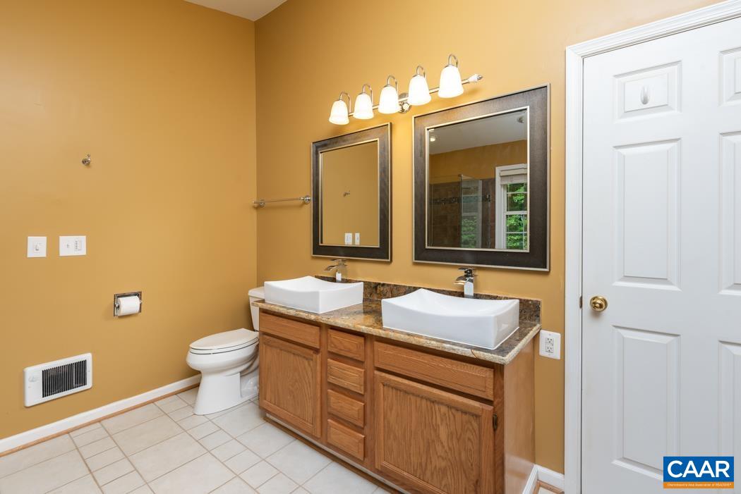 164 Wind Ridge Drive Ruckersville, VA 22968 - Photo 19 of 51 a bathroom with a sink and a mirror