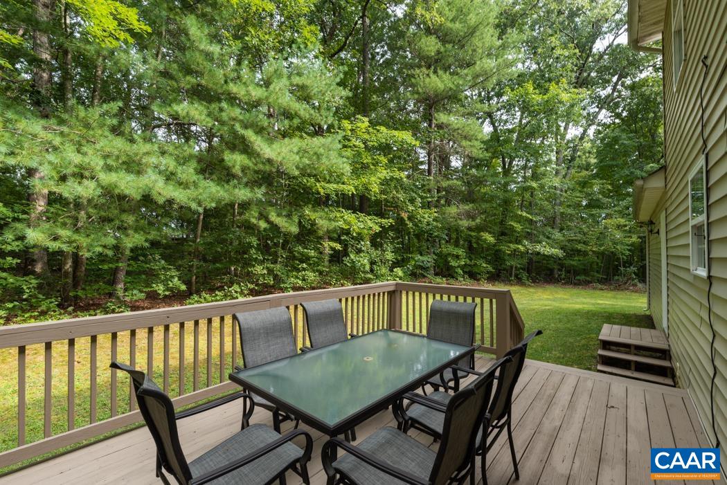 164 Wind Ridge Drive Ruckersville, VA 22968 - Photo 28 of 51 a view of a deck with a table and chairs with wooden floor and fence
