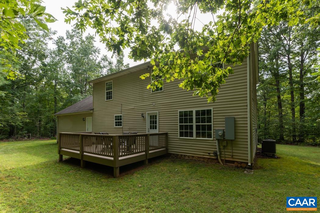 164 Wind Ridge Drive Ruckersville, VA 22968 - Photo 31 of 51 a backyard of a house with wooden deck and yard