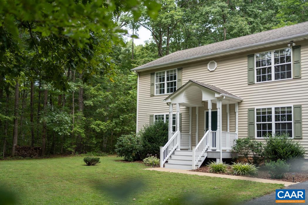 164 Wind Ridge Drive Ruckersville, VA 22968 - Photo 36 of 51 a front view of a house with a yard and potted plants