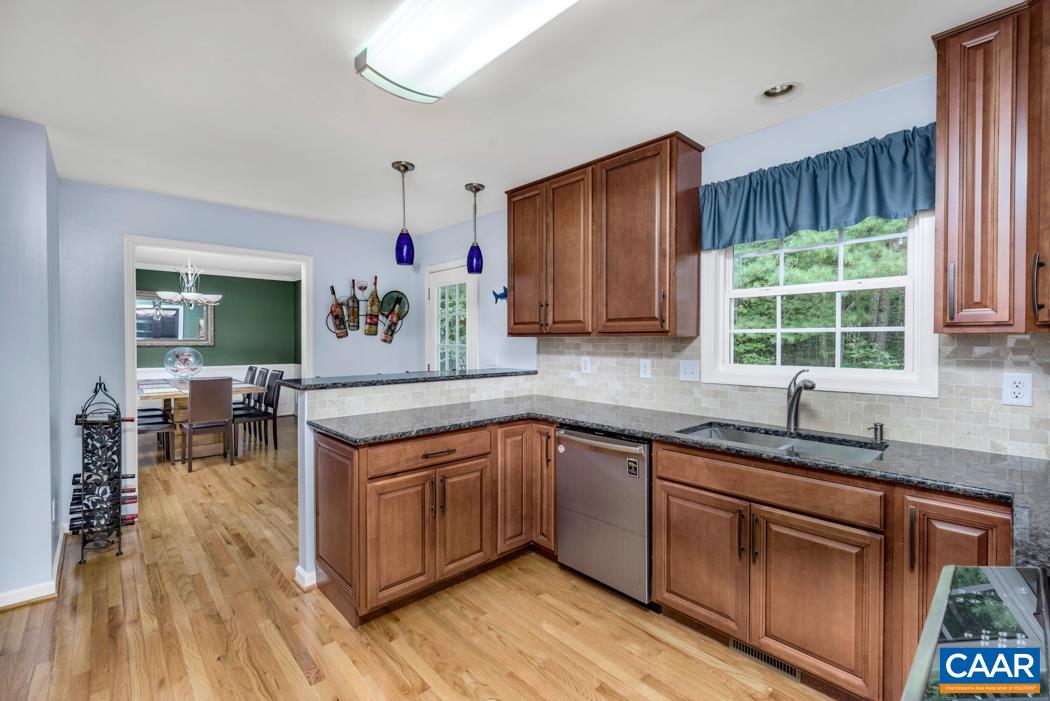 164 Wind Ridge Drive Ruckersville, VA 22968 - Photo 9 of 51 a kitchen with stainless steel appliances granite countertop wooden floors and sink