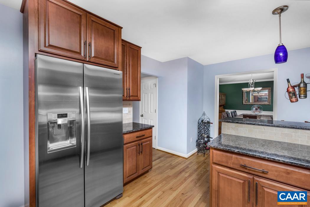 164 Wind Ridge Drive Ruckersville, VA 22968 - Photo 10 of 51 a kitchen with granite countertop stainless steel appliances a refrigerator and a counter space