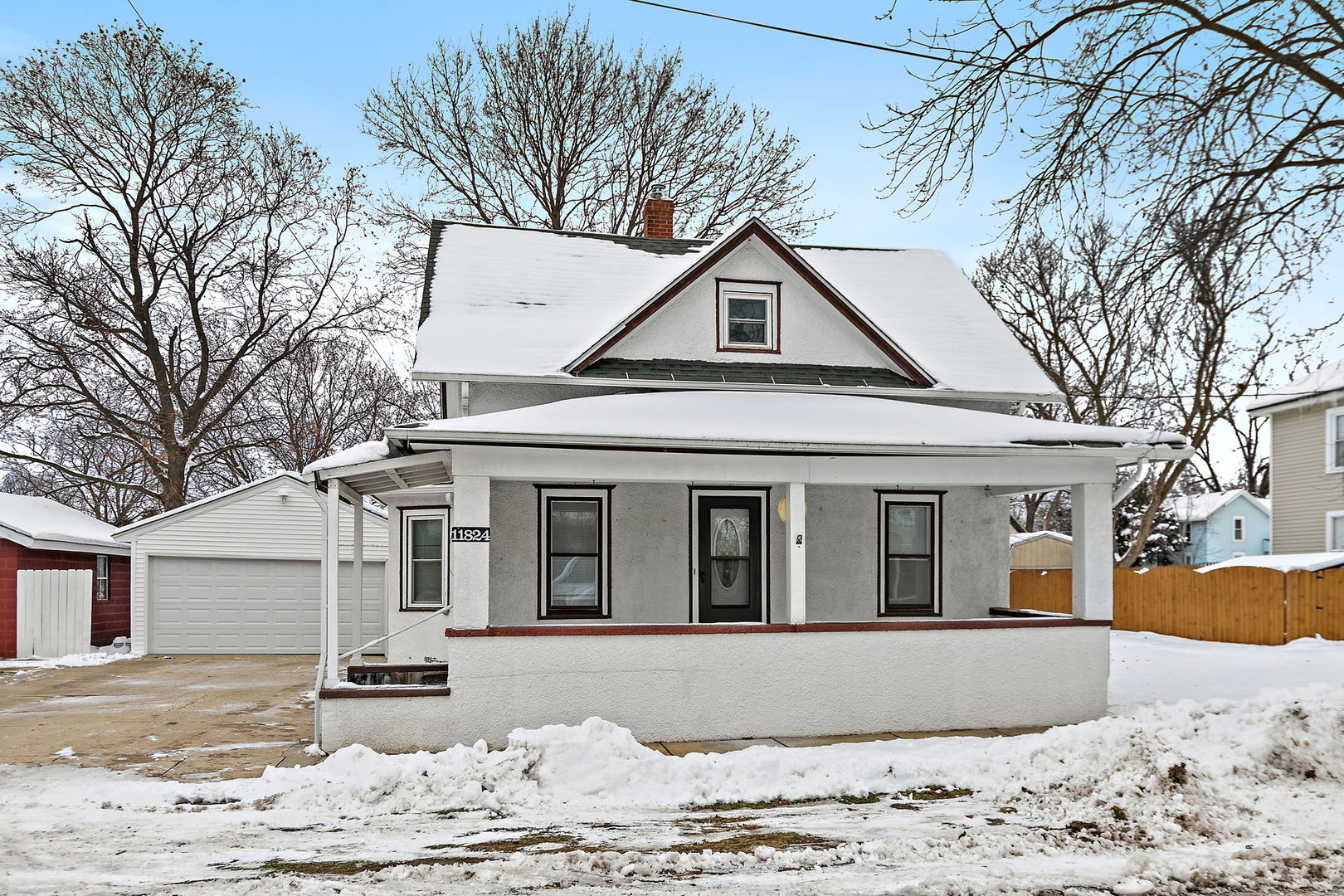 11824 Prairie Avenue Hebron, IL 60034 - Photo 2 of 22 a front view of a house with a yard covered in snow