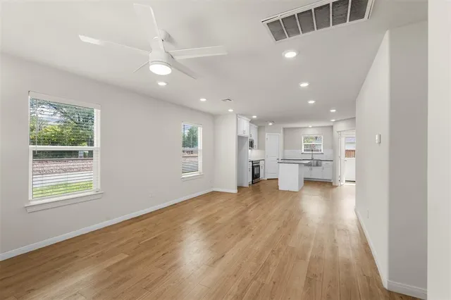 a view of kitchen and hall with wooden floor
