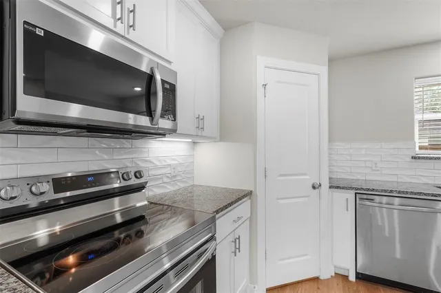 a kitchen with a stove and a microwave