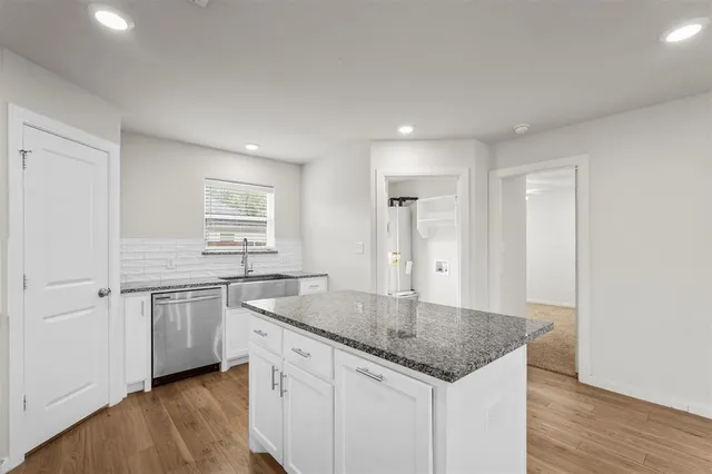 a kitchen with stainless steel appliances granite countertop a sink and a granite counter tops