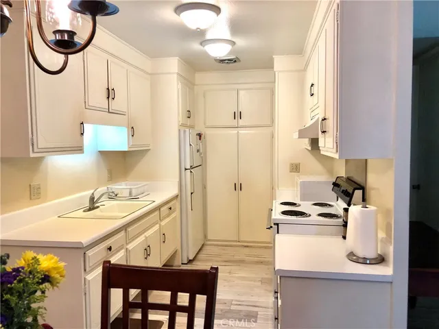 a kitchen with stainless steel appliances granite countertop a sink a stove and a refrigerator