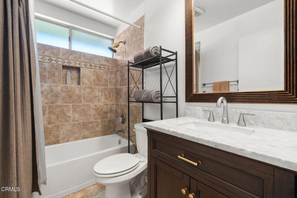 3907 United Road Agoura Hills, CA 91301 - Photo 19 of 34 a bathroom with a granite countertop sink a toilet and shower
